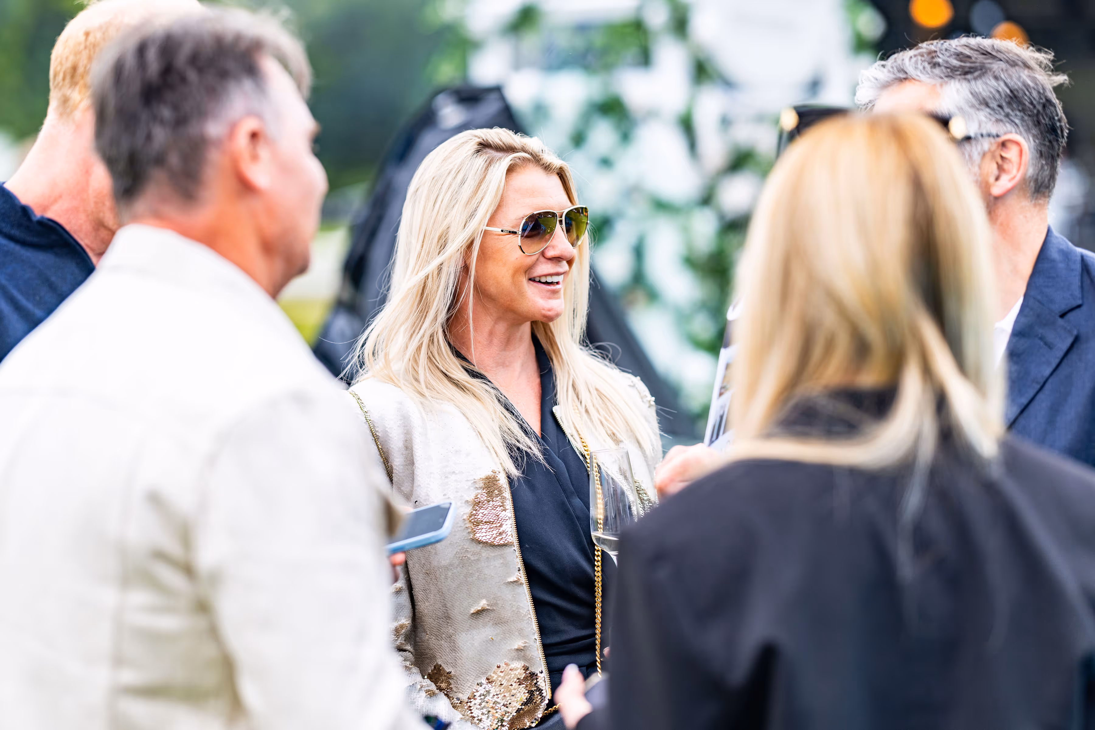 Smiling Supercar Driver member at an exclusive supercar event, wearing sunglasses and enjoying the day.