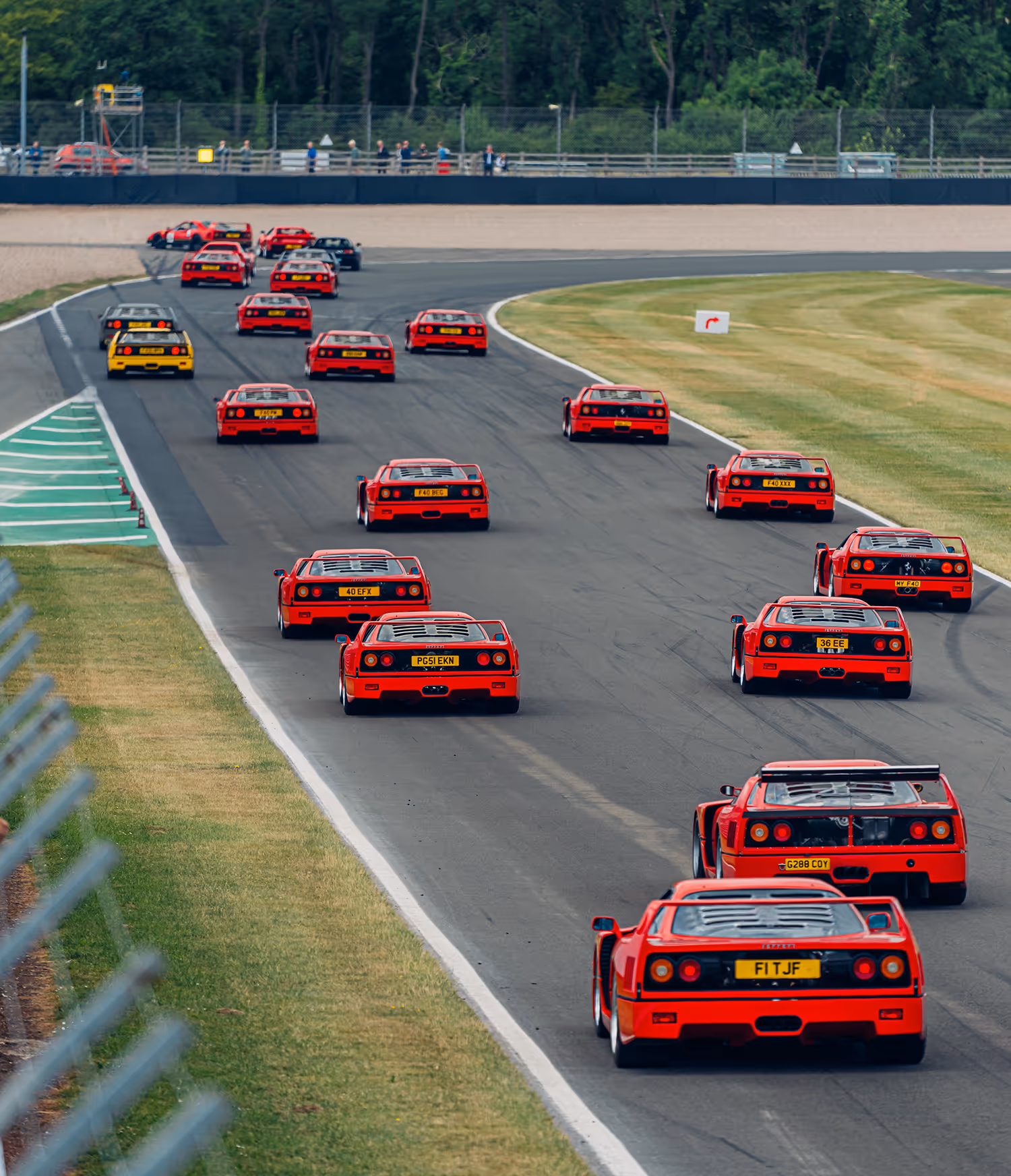 Several Ferrari F40 supercars on track at Silverstone during the Supercar Driver Secret Meet event.